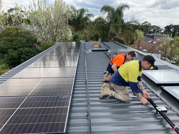 Erg Energy solar panel installation team installing a system.
