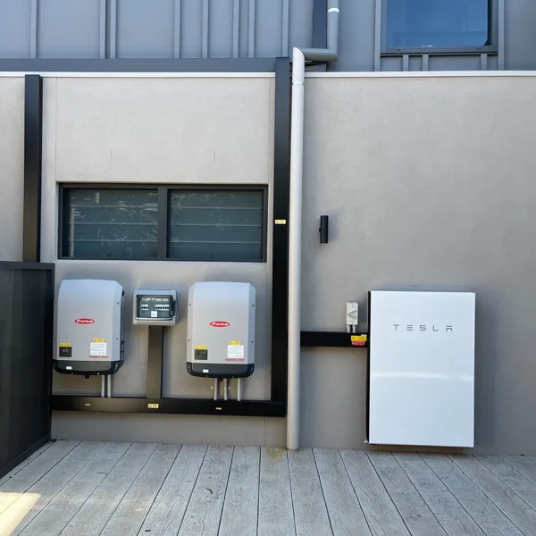 Image of a Tesla Powerwall with 2 Fronius inverters.