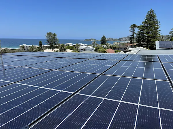 Nice shot of some solar panels with the ocean.